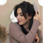 woman-combing-hair-her-beauty-routine-min (1)_11zon