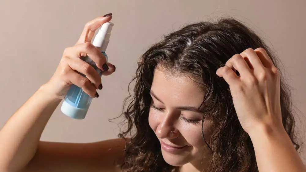 Applying herbal hair treatment to reduce hair fall and improve scalp health